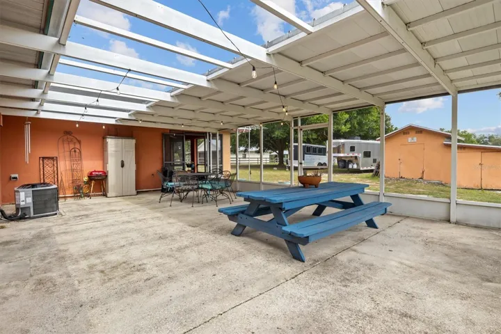 additional covered back patio, one of the entryways to the bonus room from this location