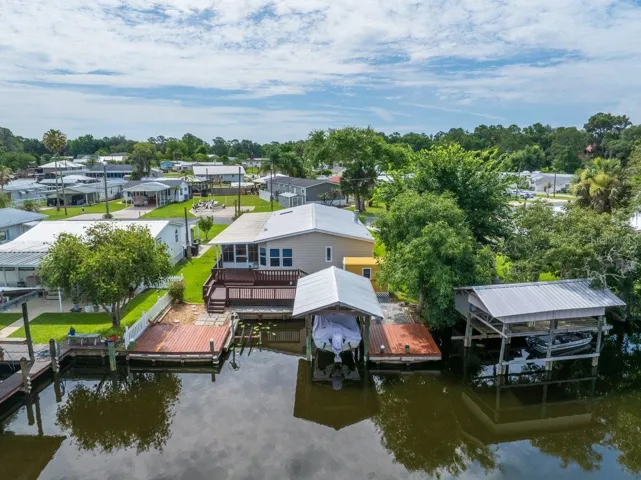 CANAL FRONT W/ BOAT HOUSE, LIFT AND MULTIPLE DECK AREAS