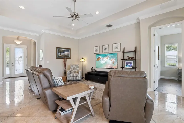 View of Great Room w/ spacious entertainment wall & Foyer entryway