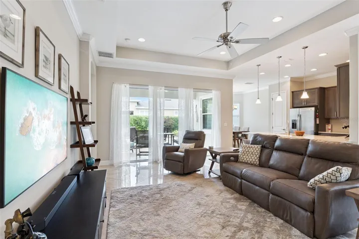 View of Great Room, Kitchen & stone paver patio w/ privacy hedge
