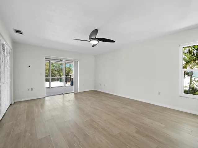 Primary bedroom, sliders to screened lanai & upper deck