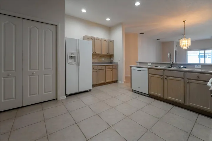 View of Refrigerator, dishwasher and Laundry Closet on left