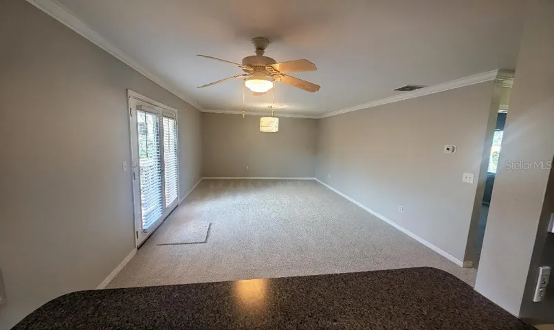 Kitchen looking through pass-through to dining/living room