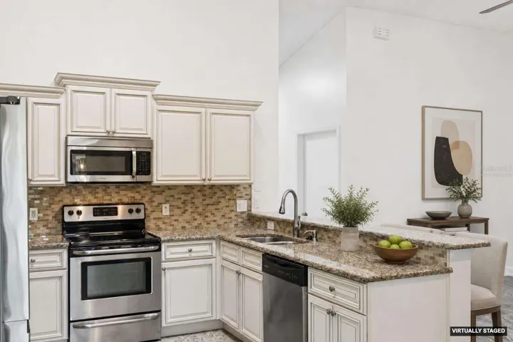 *Virtually Staged* Stainless steel appliances, crown molding on the cabinets &amp; granite countertops