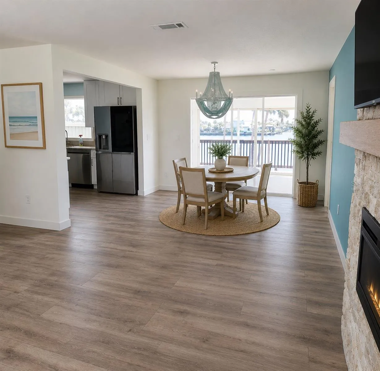 Virtually Staged. Dining Room open to Living Room, kitchen, and florida room with a view of the water