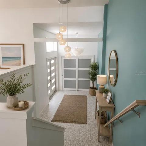 Virtually Staged. Open foyer with designer tile and a stunning shell chandelier