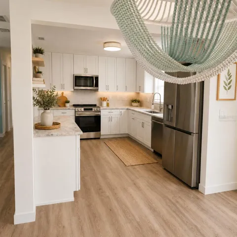 Virtually Staged. Kitchen View from dining room with shaker cabinets, quartz countertops, designer backsplash, & LG Appliances plus the view!