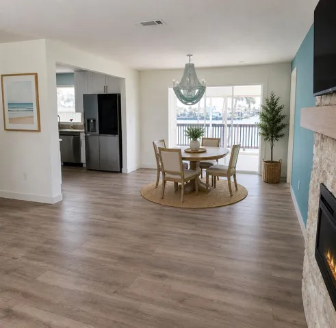 Virtually Staged. Dining Room open to Living Room, kitchen, and florida room with a view of the water