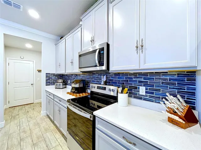 Thoughtful upgrades elevate this space, from the elegant cabinetry hardware to the eye-catching backsplash and expansive prep areas. Every detail was carefully selected to blend style with everyday functionality.