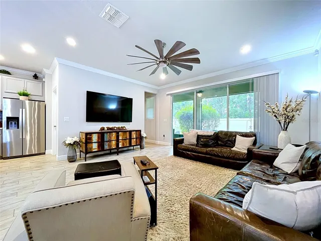 Anchored by a statement multi-blade ceiling fan and generous wall space for media and furnishings, the great room offers flexibility to fit your lifestyle and personal design style.