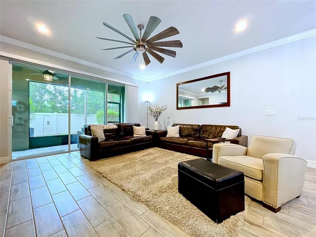 Large sliding glass doors fill the living space with natural light and create a seamless transition to the covered screened lanai, extending your living and entertaining space outdoors