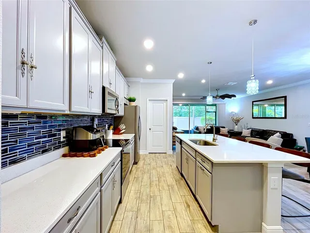 The kitchen's seamless connection to the living and dining areas creates an ideal setting for entertaining, allowing guests and conversations to flow naturally throughout the main level.