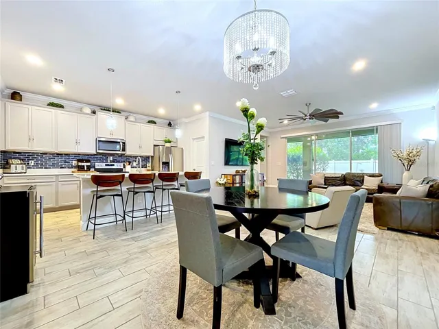 Light-filled and spacious, the heart of the home combines comfortable living with stylish design. Large sliding glass doors frame peaceful backyard views while creating a seamless connection to the outdoor living area.