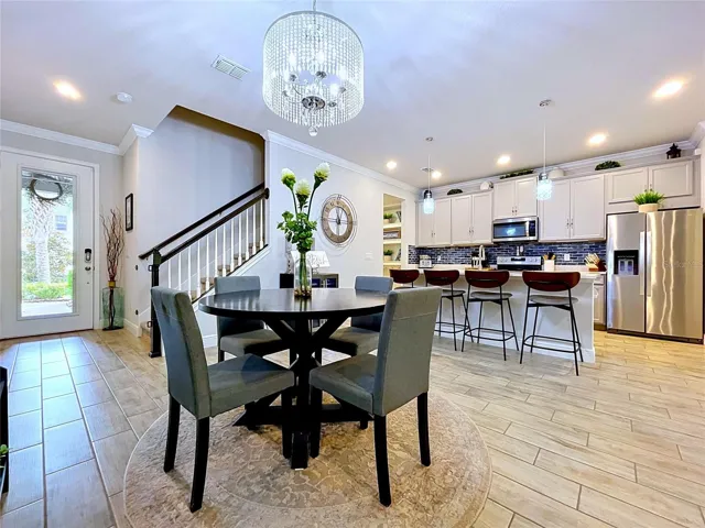 Designed for modern living, the open-concept floor plan seamlessly connects the dining area, kitchen, and living spaces. The expansive layout makes entertaining effortless while maintaining a bright, airy feel throughout.