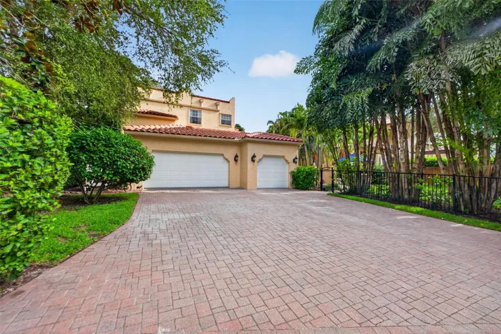 oversized three-car Oversized 3 car garage and expansive paver motor court