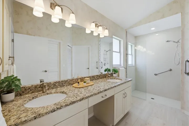 Primary bathroom with double vanity and walk in shower