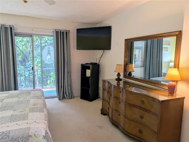 Master bedroom, with views of trees and greenery beyond