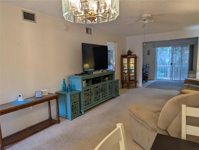 Living room with quiet, relaxing sofa & work area beyond.