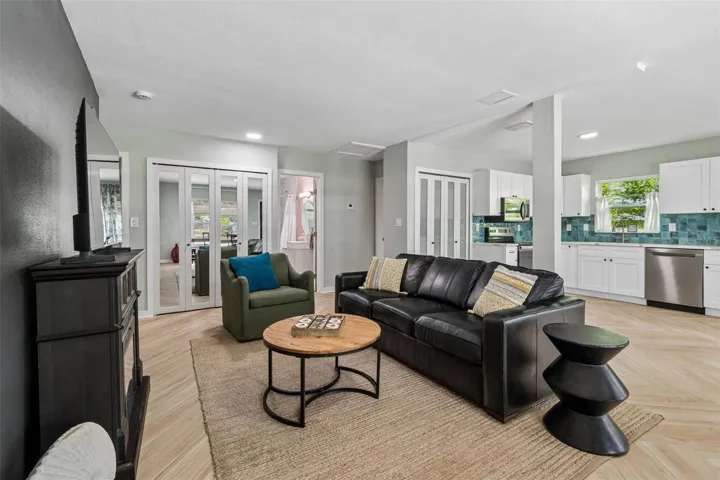 Great room with a double door inside laundry closet in the hall