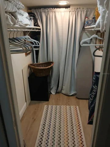Primary bedroom walk in closet