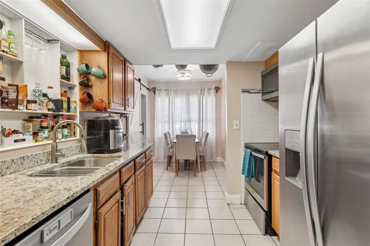 The Kitchen has been tastefully renovated with GRANITE COUNTERTOPS, solid wood cabinetry, and STAINLESS STEEL APPLIANCES, creating a space that's as functional as it is attractive.