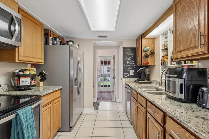 The Kitchen has been tastefully renovated with GRANITE COUNTERTOPS, solid wood cabinetry, and STAINLESS STEEL APPLIANCES, creating a space that's as functional as it is attractive.