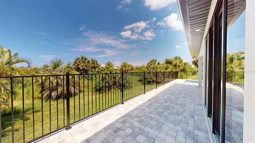Back patio that leads to door to 1/2 bathroom