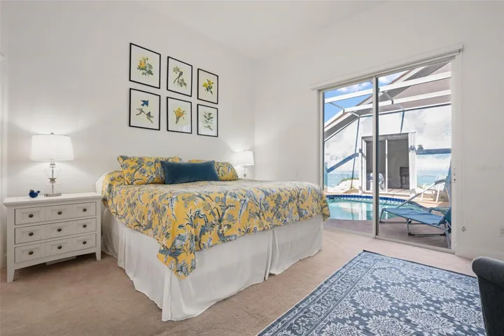 Primary bedroom with slider to pool