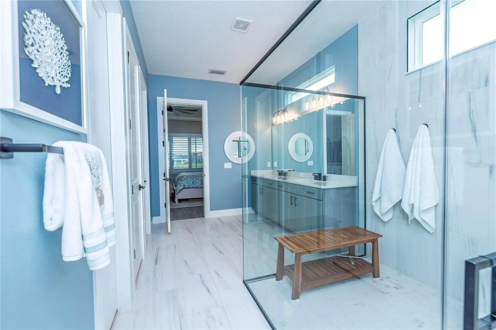 Primary ensuite bathroom with large shower and walk-in closet.