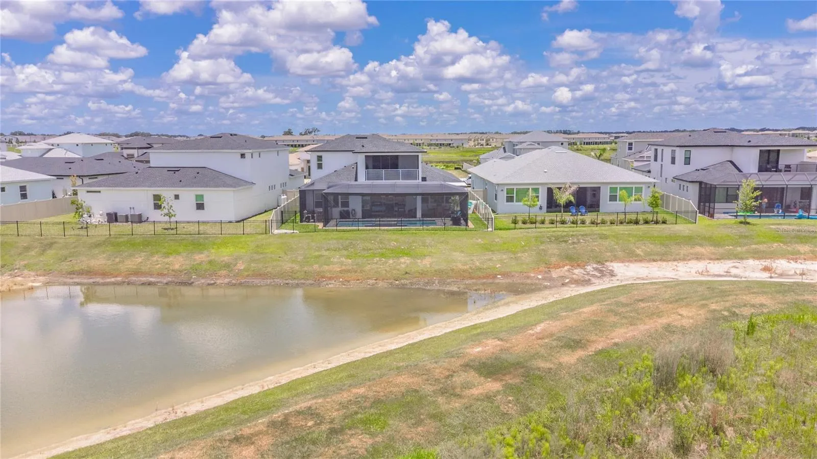 View of the back of the home and water.