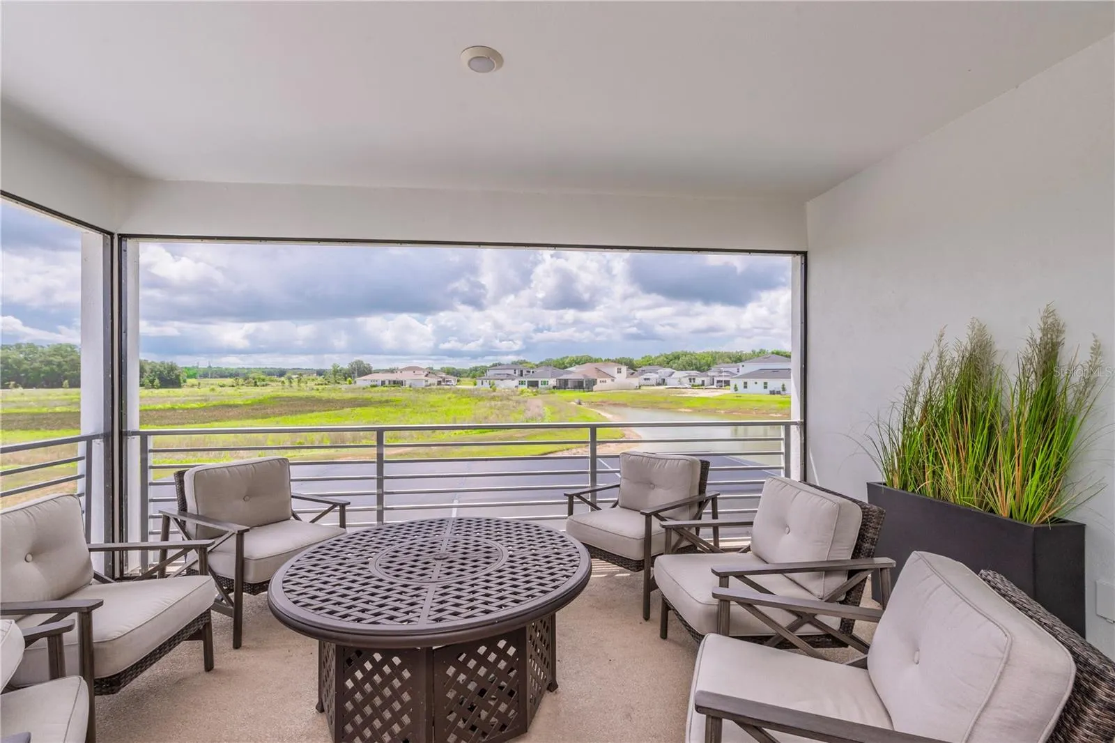 Upstairs screen balcony overlooking the water view.