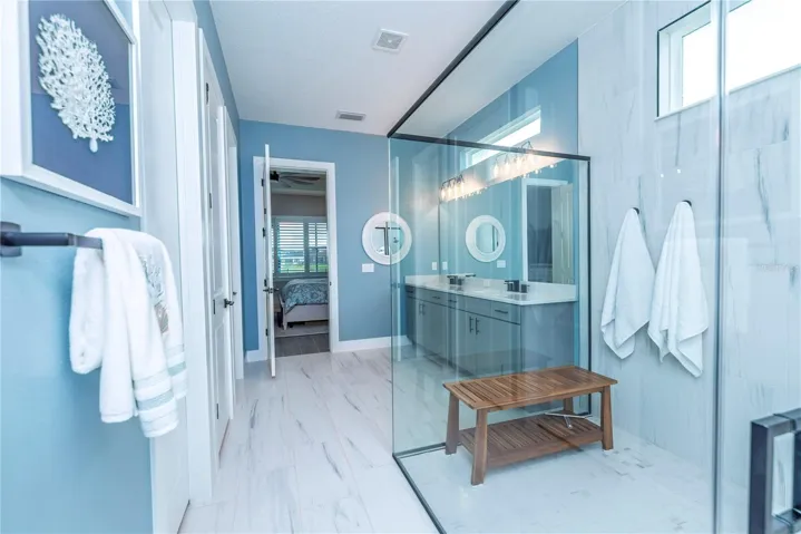 Primary ensuite bathroom with large shower and walk-in closet.