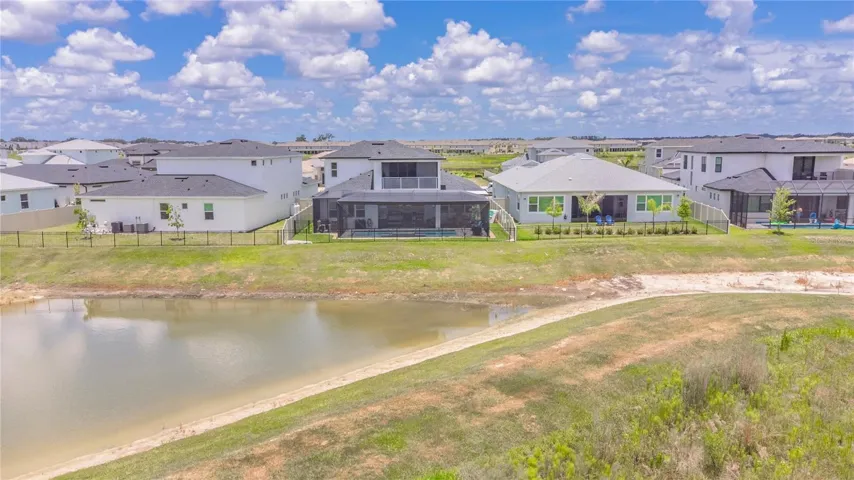 View of the back of the home and water.