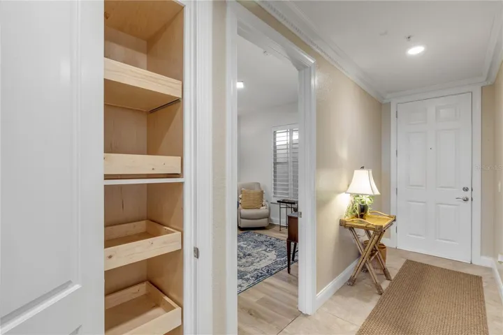 Front entrance with closet and pull out shelves