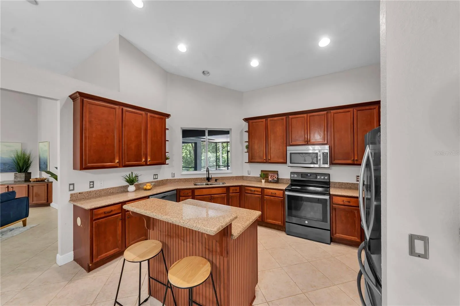 Spacious kitchen with Cherry wood cabinets and roll out drawers