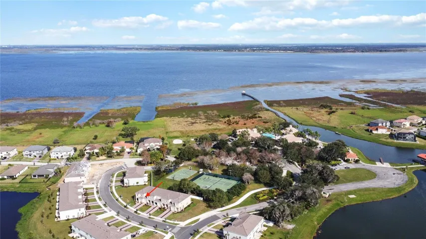 Aerial view conveys the home's prime location as it backs to the Clubhouse and all the other amenities. Lake Toho seen from above.
