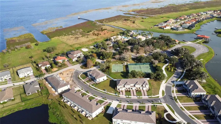 Aerial view conveys the home's prime location as it backs to the Clubhouse and all the other amenities. Lake Toho seen from above.