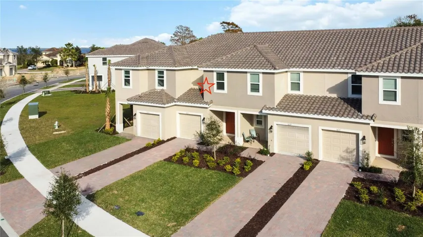 Front Exterior features barrel tile roof, brick paved driveway, front porch and one car garage.