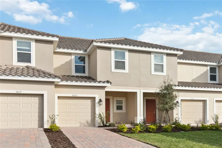 Front Exterior features barrel tile roof, brick paved driveway, front porch and one car garage.