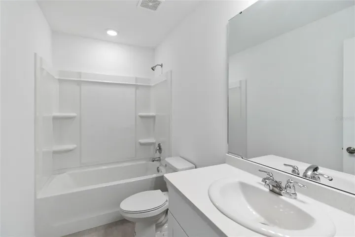 Guest Bathroom with Quartz counters and recessed lighting.