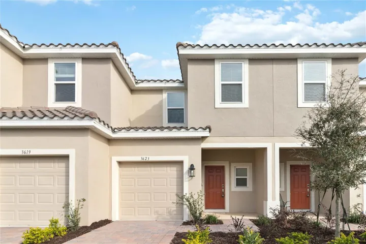 Front Exterior features barrel tile roof, brick paved driveway, front porch and one car garage.