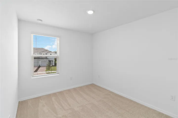 Guest Bedroom three with recessed lighting.