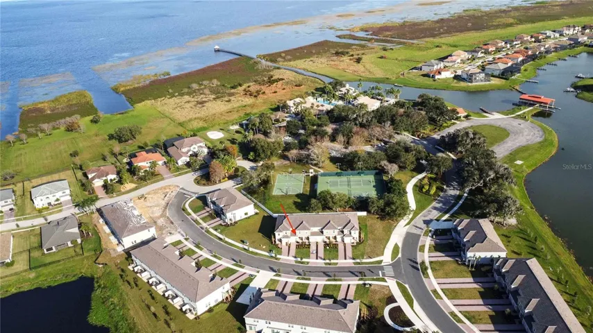 Aerial view conveys the home's prime location as it backs to the Clubhouse and all the other amenities. Lake Toho seen from above.