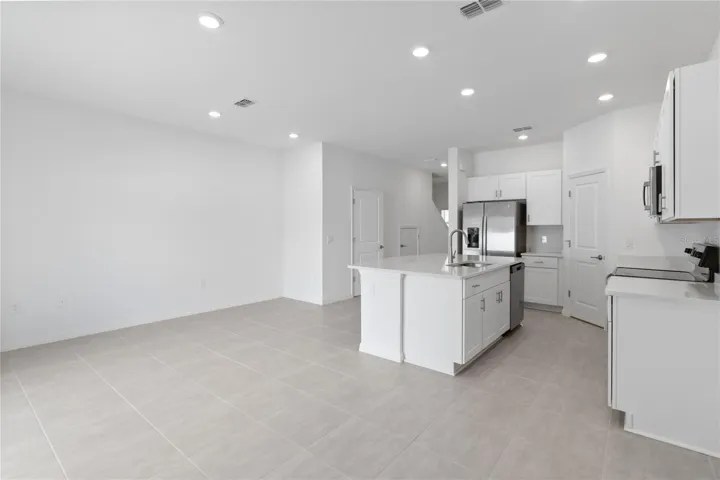Open concept Great Room and Dinette space, leading into Kitchen.