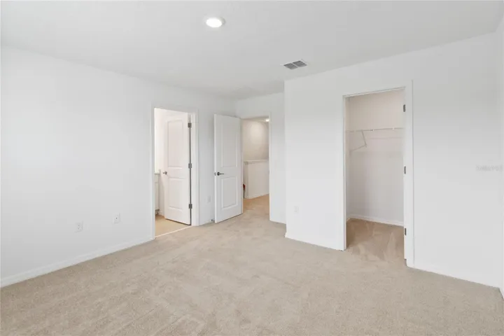 Primary Bedroom with recessed lighting, Walk-in closet and En-Suite Bathroom.
