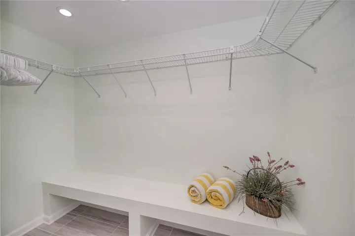 Oversized Walk-In Closet with Built in Storage Bench.