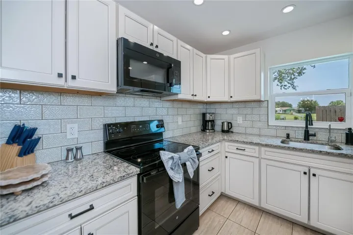 Chef-Worthy Kitchen Featuring Custom Stone Countertops and Designer Tile Backsplash