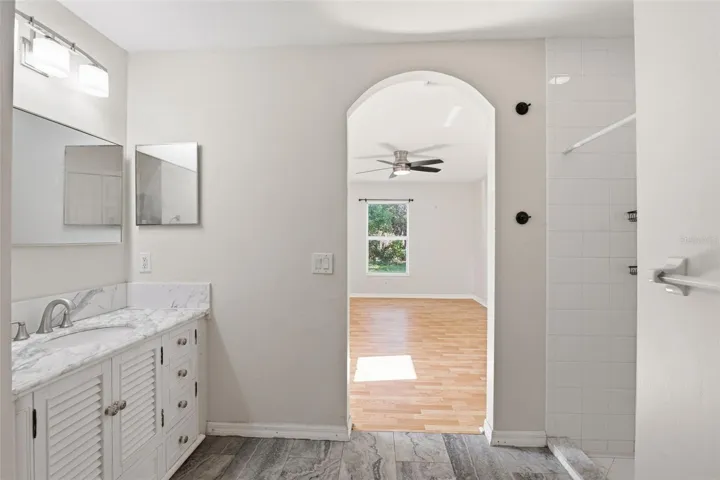 Primary Bathroom with Stylish Vanity with Marble Look Countertop.