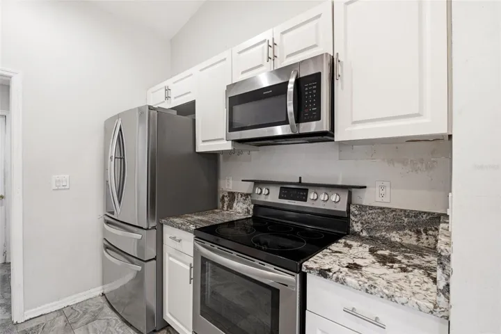 Updated Kitchen with Granite Countertops and Stainless Steel Appliances.