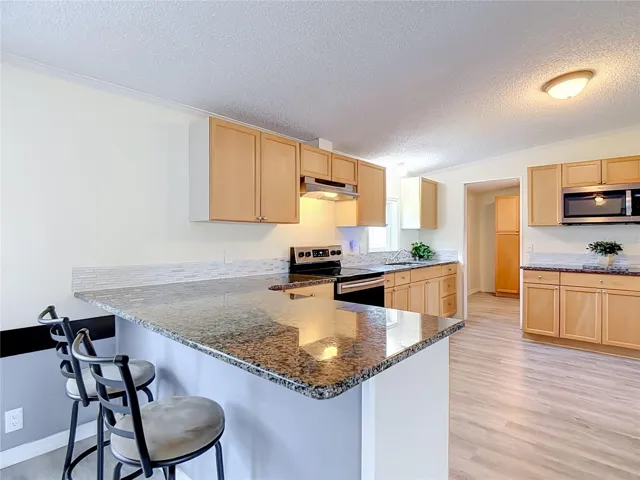 Kitchen has been remodeled with new cabinets, backsplash stainless steel appliances and granite countertops.